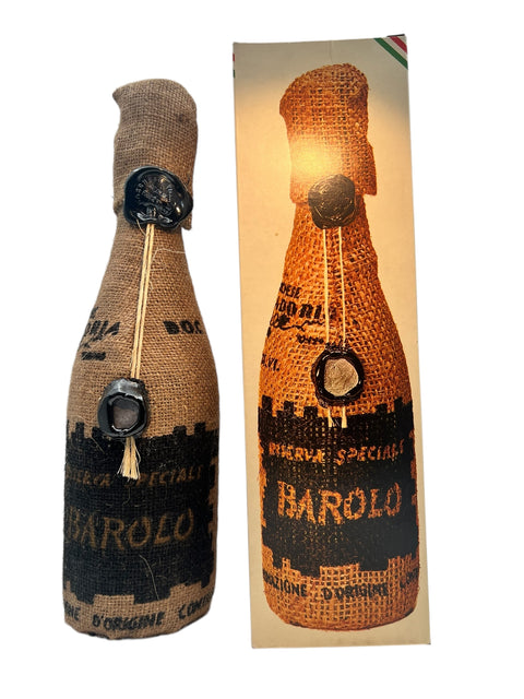 Bottle of red wine Barolo Riserva Speciale 1960 with rustic packaging